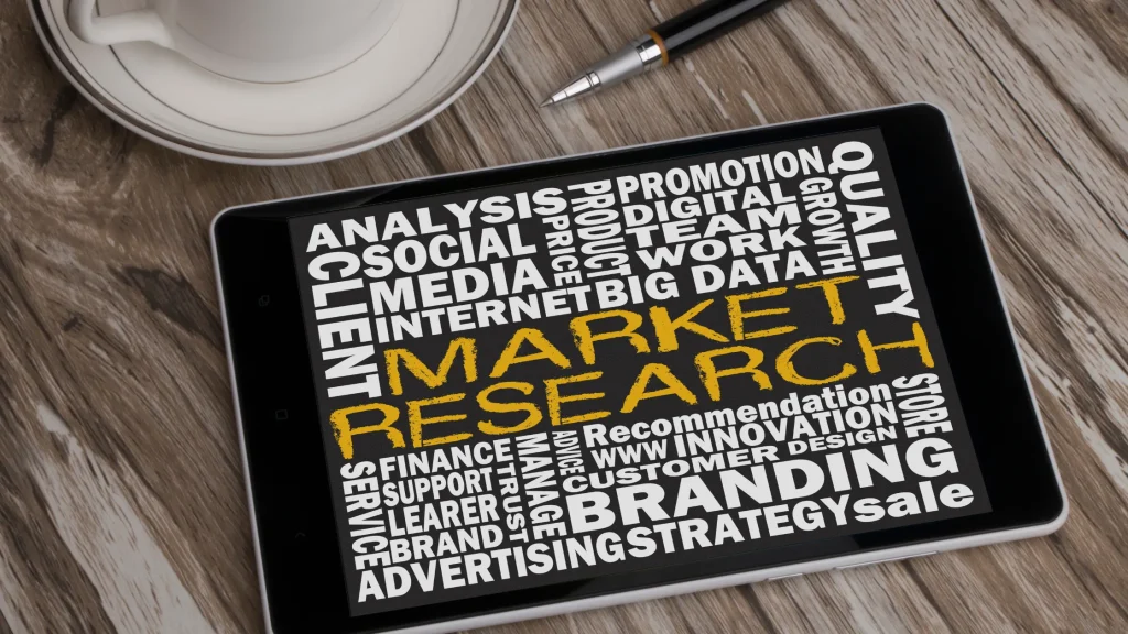 A tablet displaying market research keywords such as branding, strategy, and customer analysis for digital marketing.