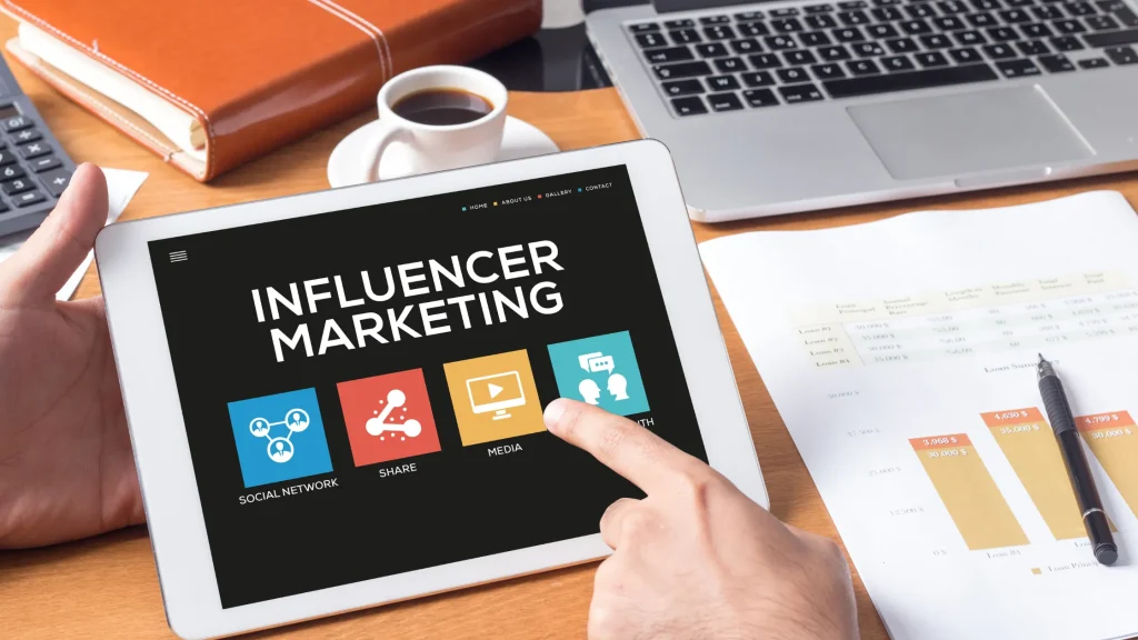 Tablet showing influencer marketing interface with social network, media, and share icons for small businesses.