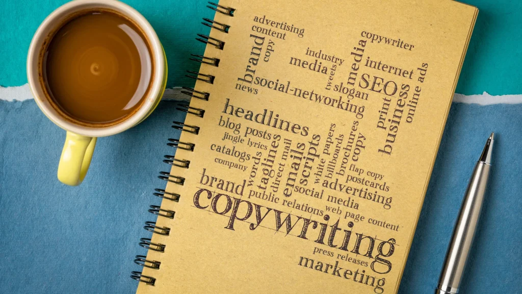A coffee cup and a notebook with SEO-related terms like "copywriting," "marketing," and "SEO."