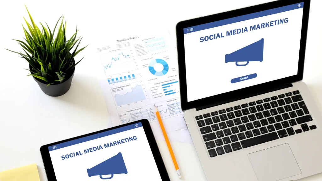 A laptop and tablet displaying social media marketing graphs, showing growth potential for startups.