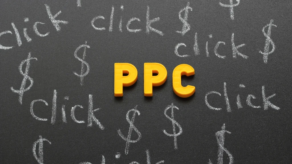 PPC concept with 'click' and dollar symbols drawn in chalk