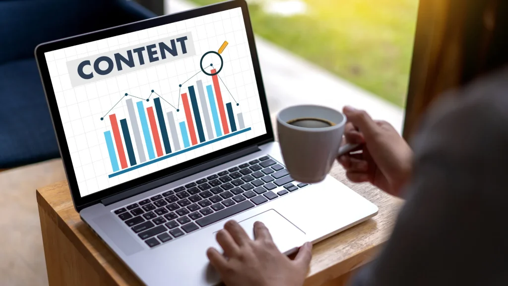 Laptop displaying content marketing graphs, highlighting SEO content writing services in the UK.